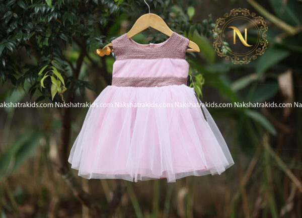 Pastel pink tulle net frock with pastel lavender embroidery fabric on neckline and waistline